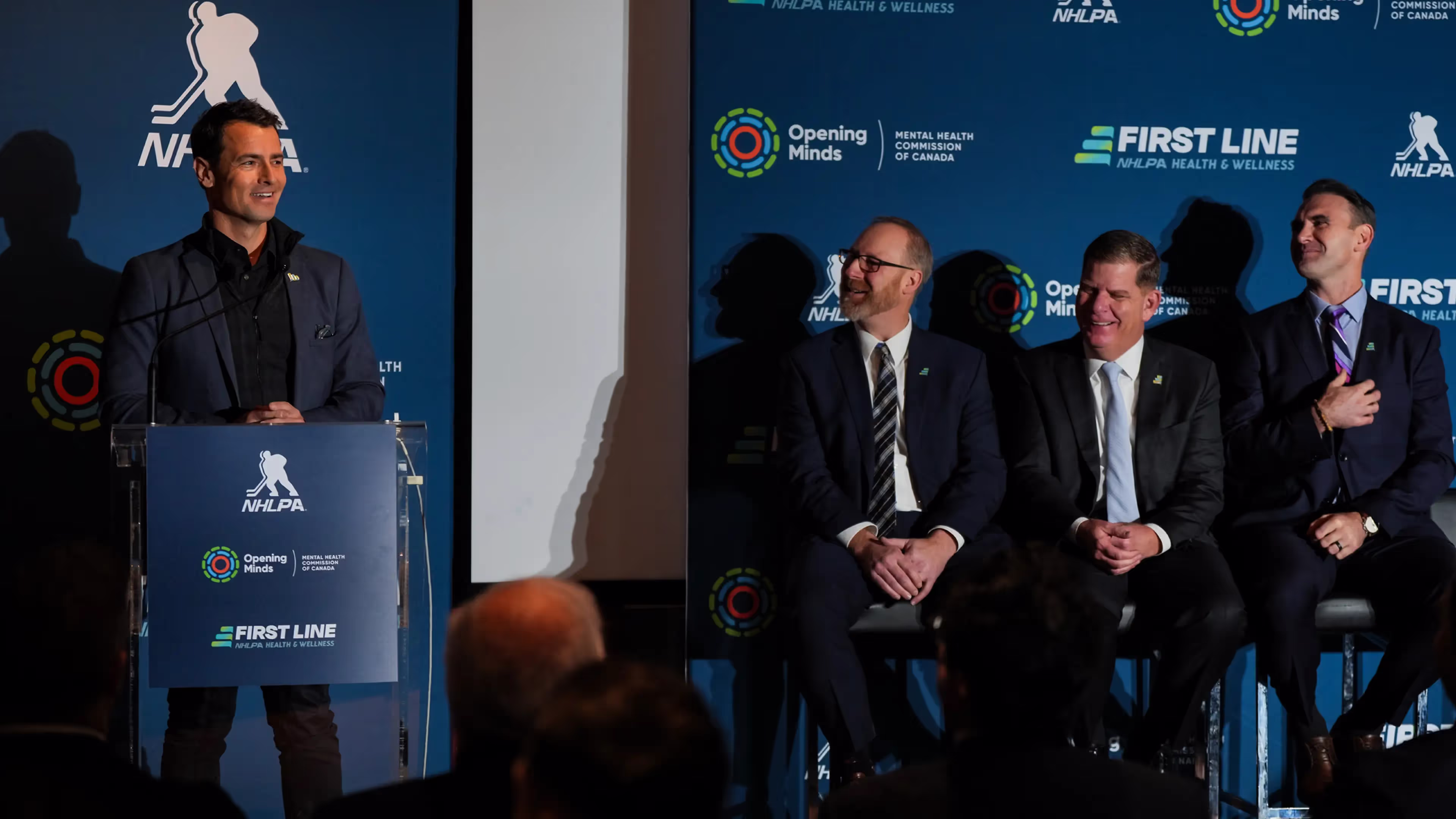 A photo from a press conference of the First Line program, which is a joint initiative of Opening Minds and the NHLPA