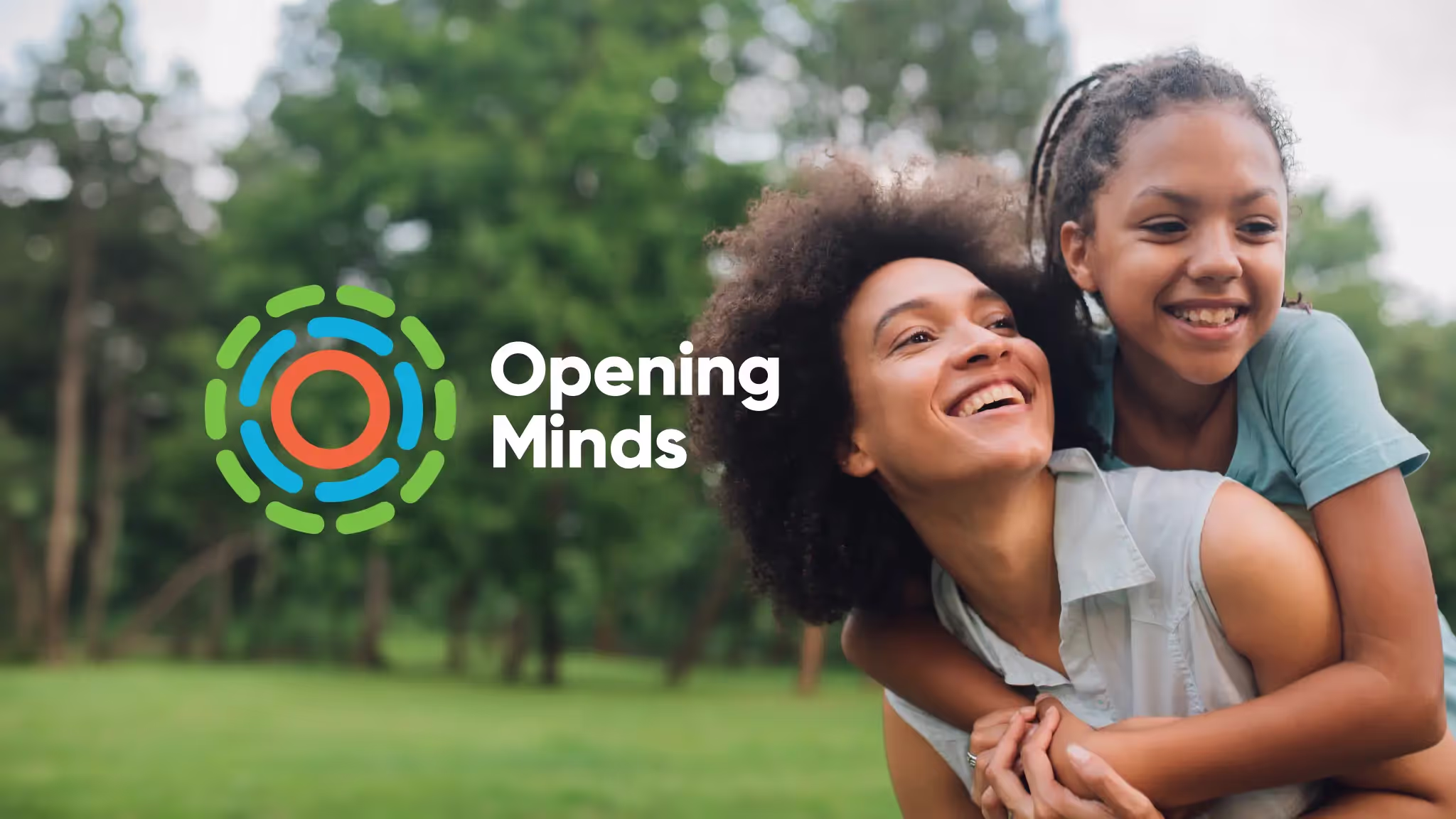 A mother and daughter embracing each other while laughing. The Opening Minds logo is superimposed on the photo.